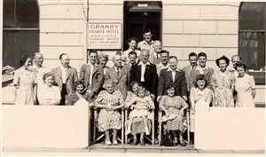 Photo:Portrait of some of the Bassett family and guests outside the Granby guesthouse, c.1950s