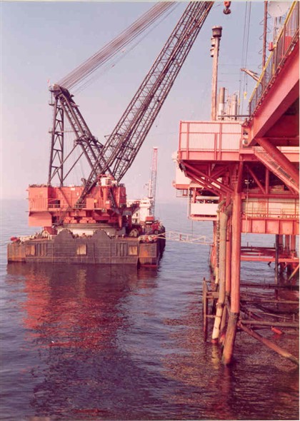 Photo:Barge along side a platform unloading its cargo