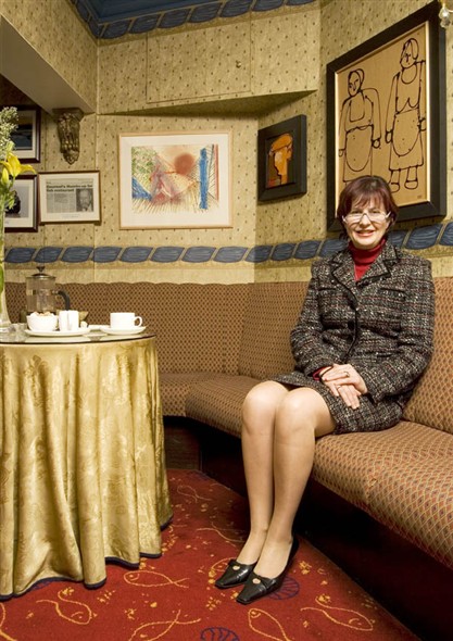 Photo:Portrait of Miriam Kikis, reataurant owner sitting at one of the tables