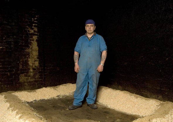 Photo:Mike Kelly on the ground floor of the smoke house with the wood shavings piled up ready to be lit