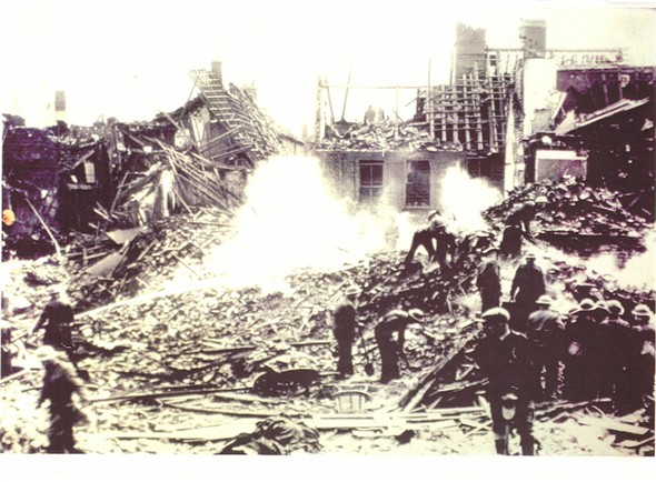 Photo:Firemen at work in the aftermath of another bombing raid