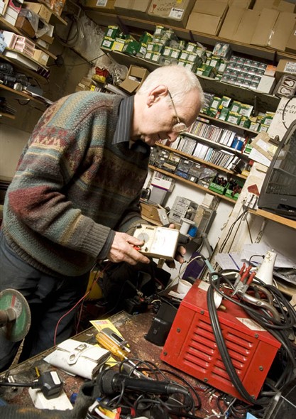 Photo:Vernon Morris carrying out repairs in the back room of his shop