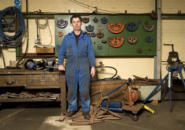 Photo:Portrait of J. Pendergast in the machine shop at Richards