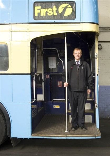 Photo:Portrait of Peter Sedge, bus driver for First buses, on the back of an old bus